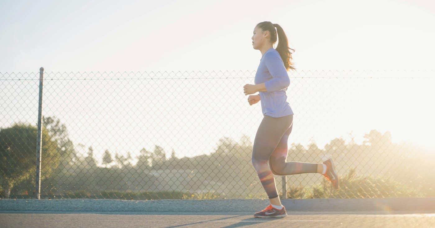 A runner in soft early-morning light